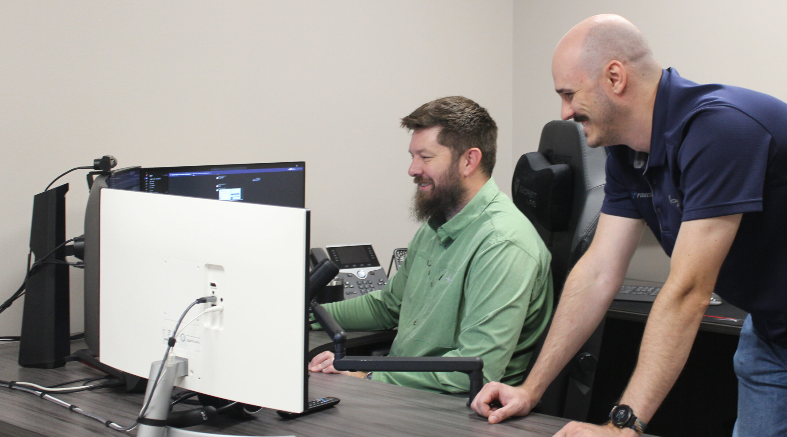two engineers having a good time helping customers